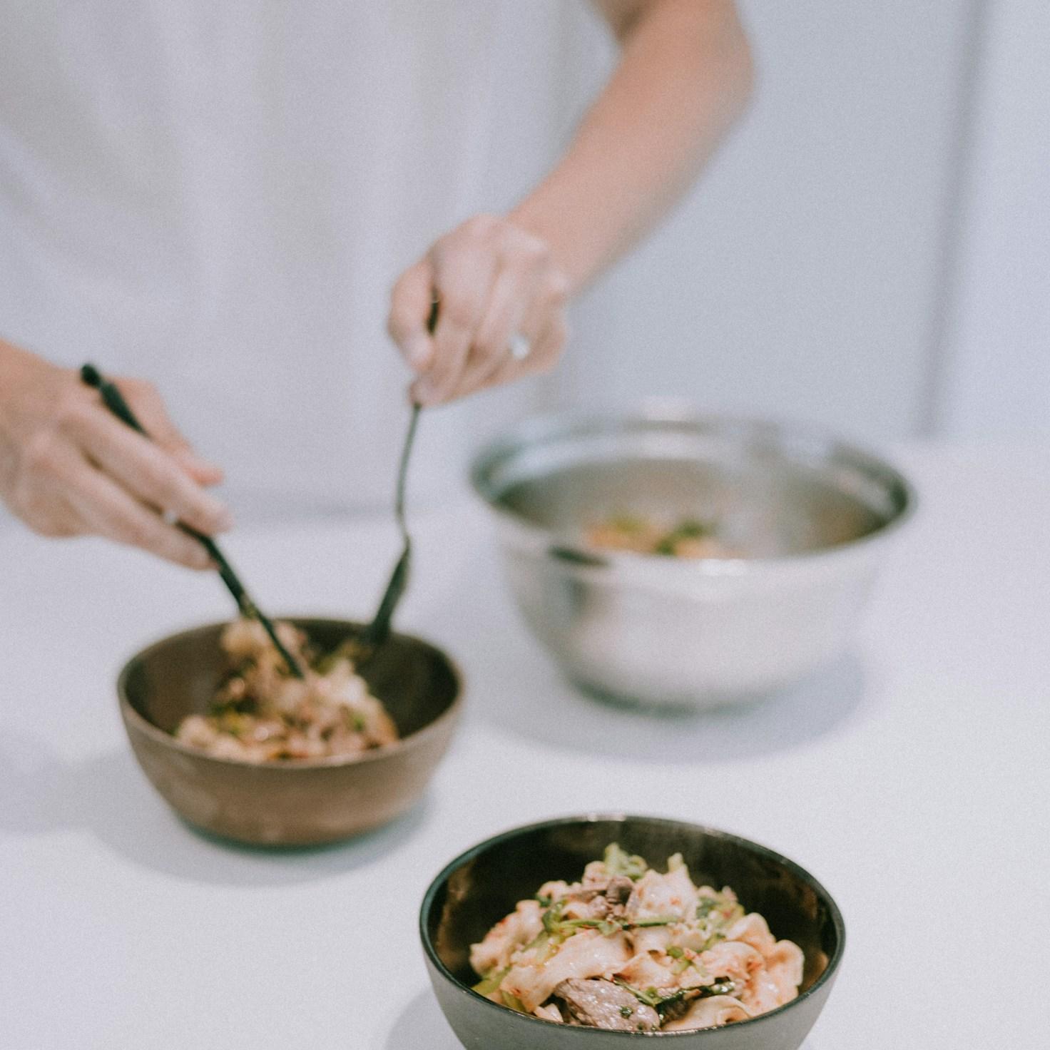 Community members collaborating in a modern kitchen space, sharing recipes and cooking techniques